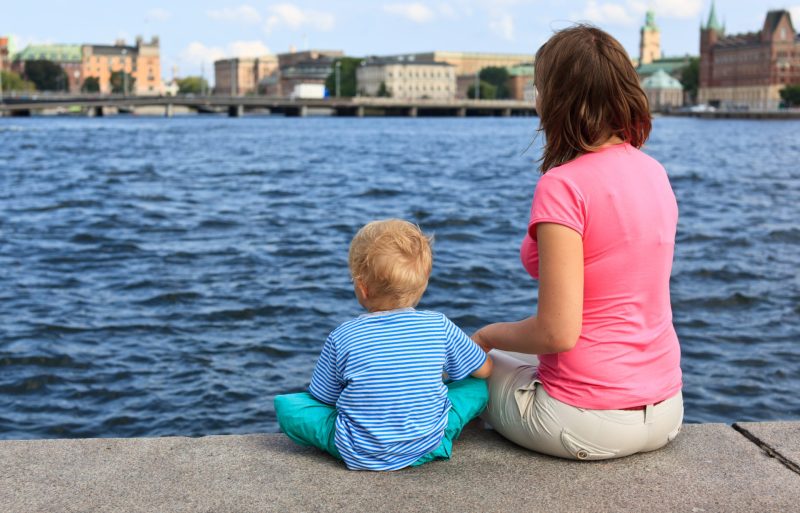 Mother and a child sitting overlooking the Stockholm landscape