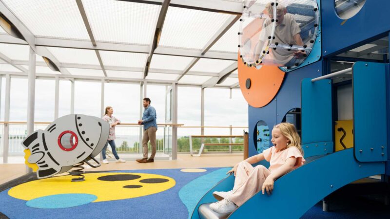 Bild på en glad flicka som leker ombord på utomhuslekplatsen Space games ombord på Finnlines fartyg.